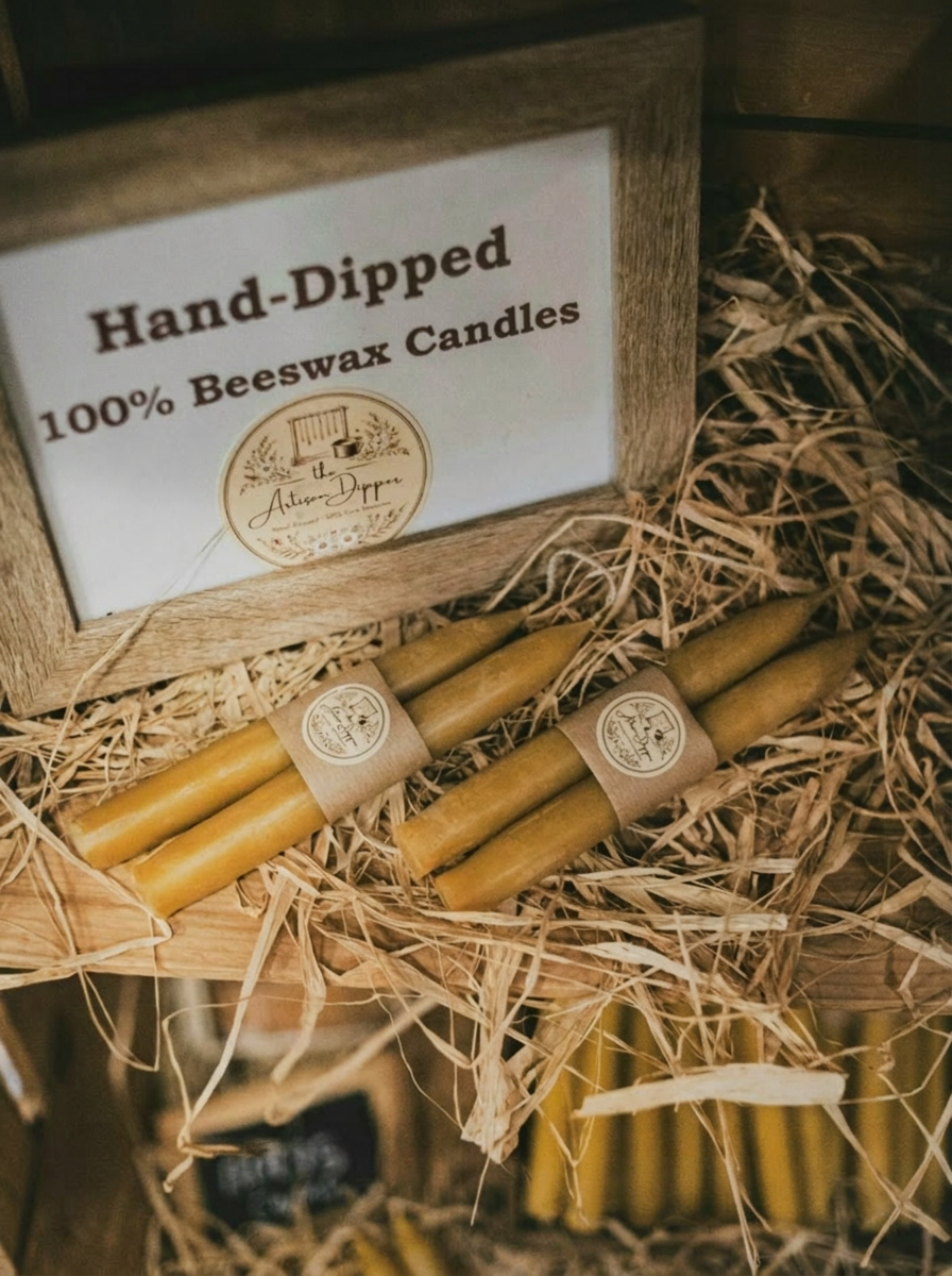 Hand-dipped 100% beeswax tapers from the Artisan Dipper, bundled in kraft paper and nestled in raffia in a wooden crate